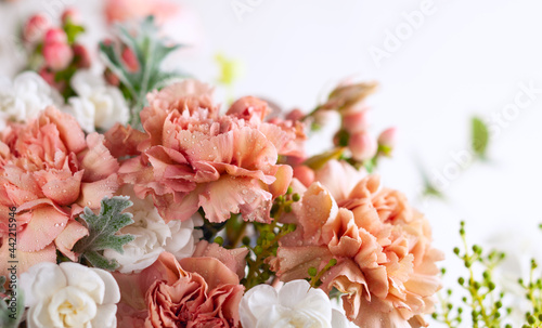 Autumn composition made of beautiful flowers with water drops and berries on ...