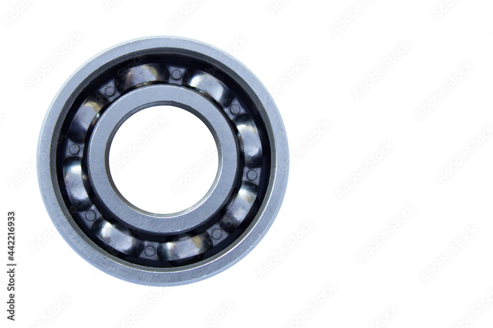 Ball bearing with steel cage close-up on a white background. The bearing is located on the left. Isolated. Copy space. Ball bearing with steel cage close-up on a white background. The bearing is located on the left. Isolated. Copy space.