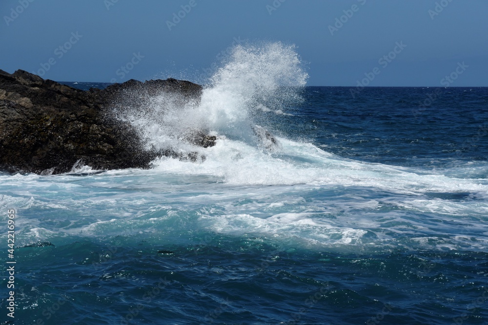 yhe waves crashing on the rocks
