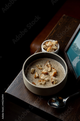 Studio shot of mushroom soup with cream and wheat bread studio advertisement shot