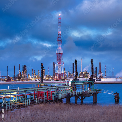 View on large petrochemical production plant on riverbank at twilight, Port of Antwerp