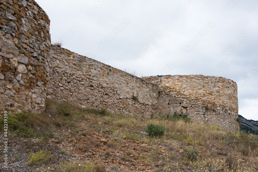Ruins of an ancient castle at Merindades, Burgos, Spain. Stone walls and grass around. Europe