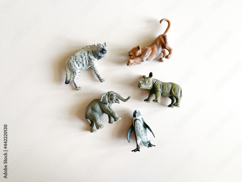 Figures of animals on a white background Children's toys: rhino, hippopotamus, zebra. The concept of children's play, montessori. many pieces to play. A gift for a child. Animal protection.