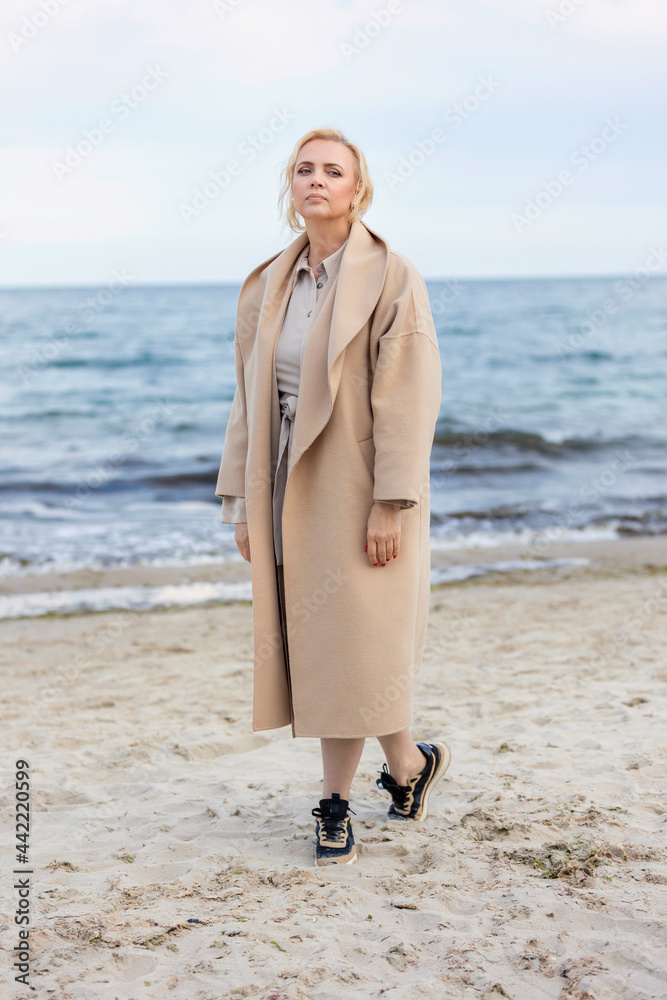 Aged woman on the background of the sea Aged woman on the background of the sea