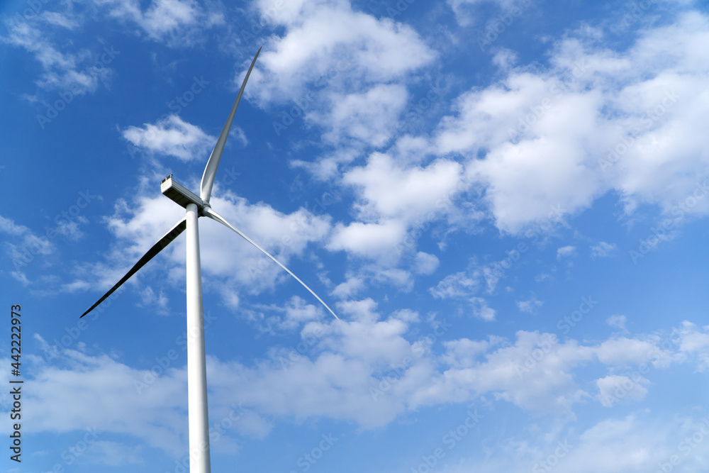 Wind turbine main rotor over blue cloudy sky Wind turbine main rotor over blue cloudy sky