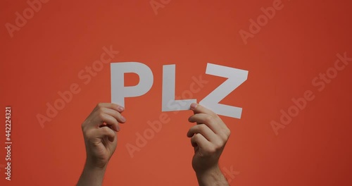 Hands raising up showing abbreviated word please. 4k video of hand with polite phrase made of carved paper for blog