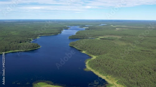 Flight over the taiga forest lake