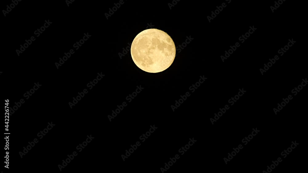 Moonrise. Moon moving in the dark sky. Time Lapse moon at night with clouds. Clouds passing by full moon at evening or nighttime. Mystery fairyland scene. Nature background Timelapse Moonrise. Moon moving in the dark sky. Time Lapse moon at night with clouds. Clouds passing by full moon at evening or nighttime. Mystery fairyland scene. Nature background Timelapse