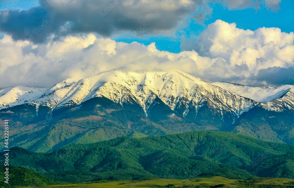 Fototapeta premium Landscape with Fagaras mountains covered with clouds and snow