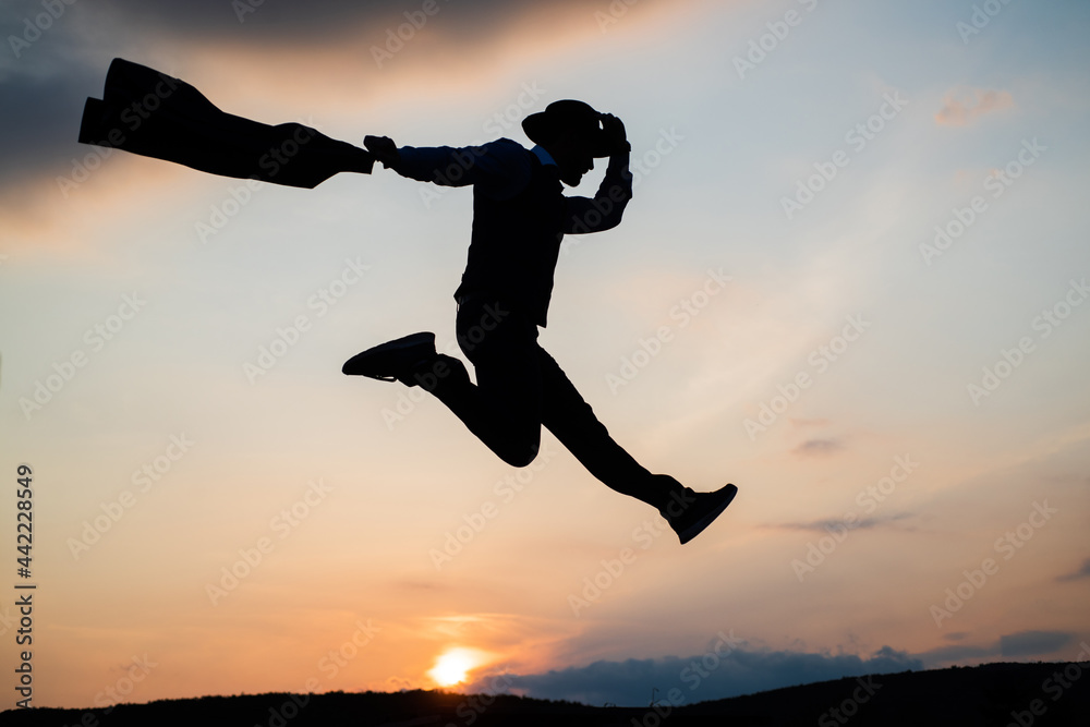 custom made wallpaper toronto digitaljumping man silhouette with hat and jacket dance against sunset sky, dancer