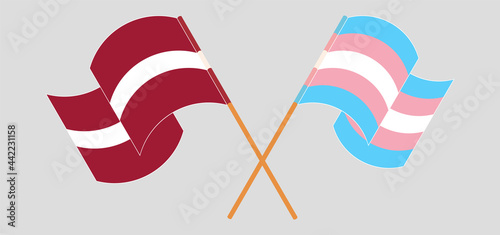 Crossed and waving flags of Latvia and transgender pride