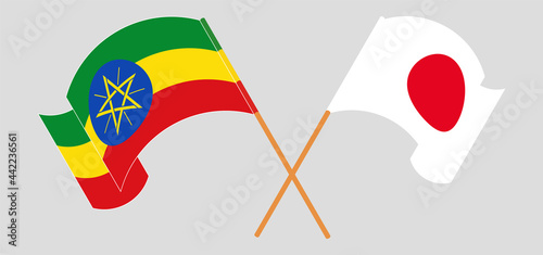 Crossed and waving flags of Ethiopia and Japan