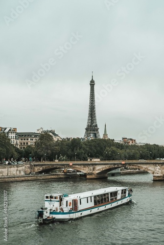Paris, France 28-06-2021: a boat crossing a pond with a view of the eiffel tower