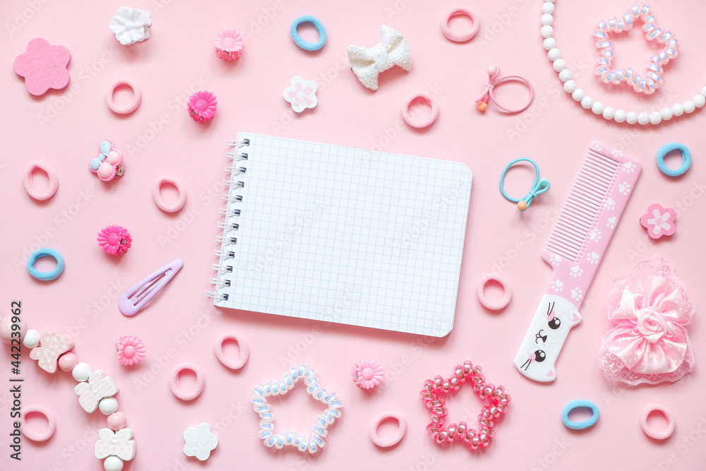 Blank notepad, cute comb with kawaii cat face and kid's hair accessories on pink pastel background Blank notepad, cute comb with kawaii cat face and kid's hair accessories on pink pastel background