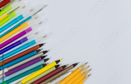 A different colored stationery in stands on a variety school supplies