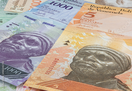 Close up to the currency of the south American country Venezuela. High inflation and weak economy increases the denomination of the banknotes. Bolivares or Bolivar money of the republic Venezuela  photo