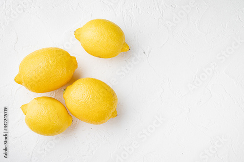 Lemon whole, on white stone table background, with copy space for text