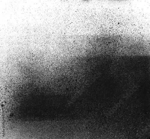 Grain texture. Abstract black and white gritty grunge background. Dark paint spray particles on paper.
