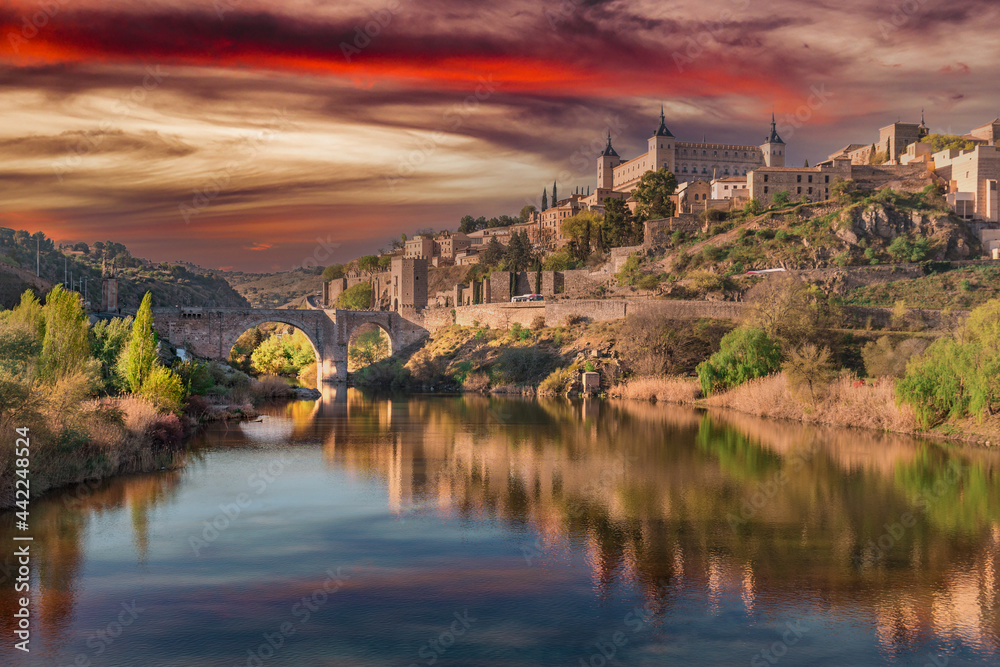 Toledo, Spain, March 27, 2019. Sunset view from the Tagus river towards the center of the city, a dreamy sky