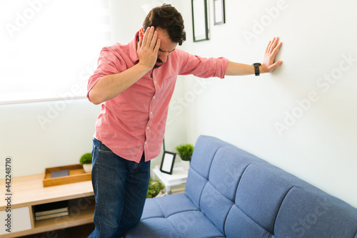 Stressed hispanic man about to faint photo