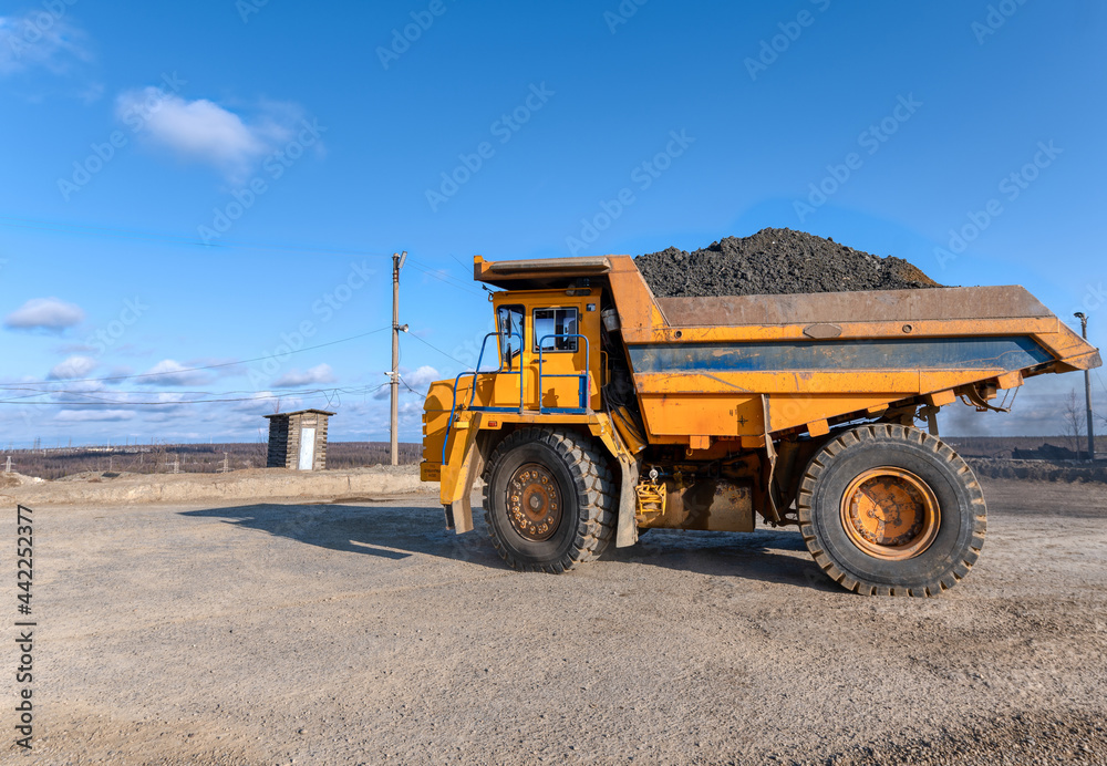 Mining truck dump truck loaded with ore. Transportation of mined ore from the open pit to the surface Mining truck dump truck loaded with ore. Transportation of mined ore from the open pit to the surface