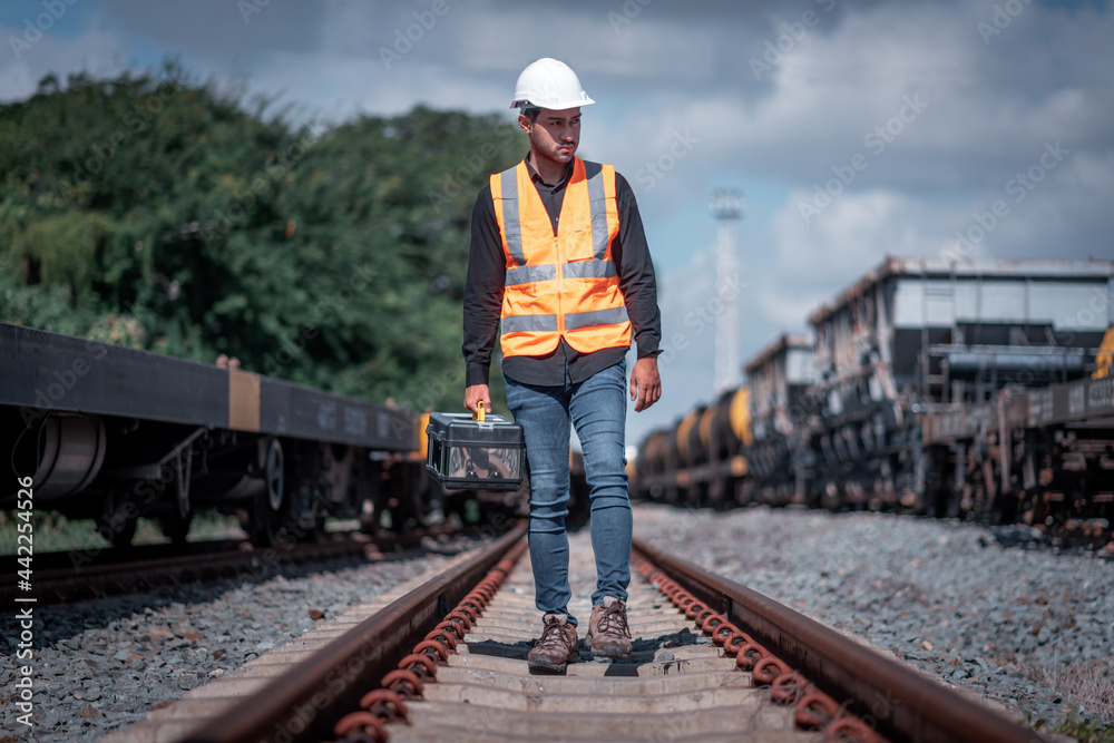 Engineer under inspection and checking construction process railway switch and checking work on railroad station .Engineer wearing safety uniform and safety helmet in work Engineer under inspection and checking construction process railway switch and checking work on railroad station .Engineer wearing safety uniform and safety helmet in work