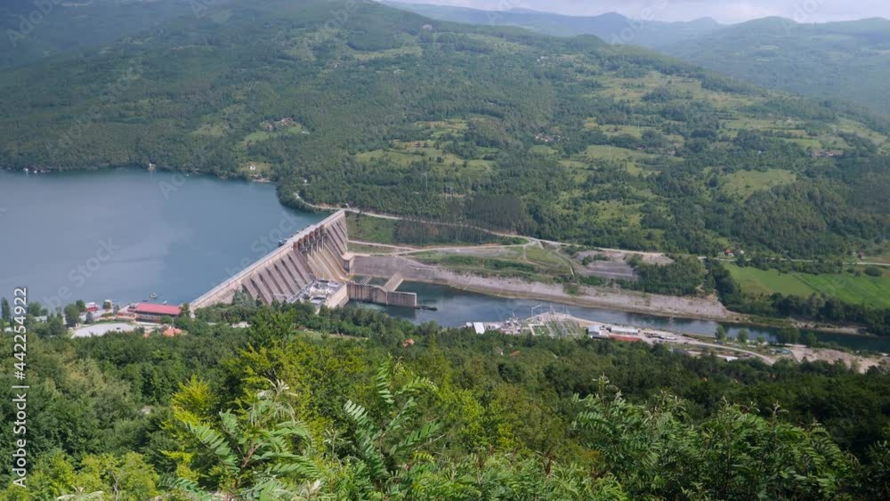 A top scenic view of a beautiful hydroelectric power plant in rich green valley. A top scenic view of a beautiful hydroelectric power plant in rich green valley.