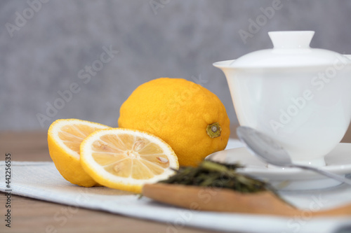 Gaiwan tea and yellow lemon on the table