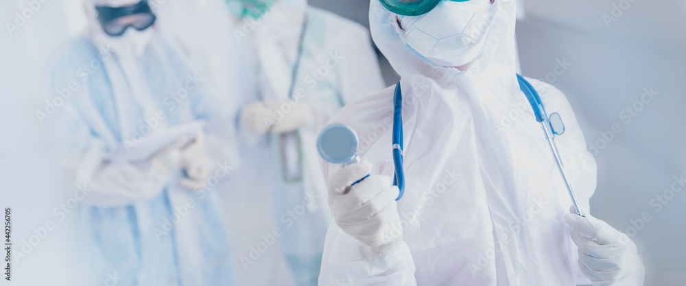Doctors and nurse team in protective suits and masks in control red area covid 19. Concept banner medical care health vs coronavirus Doctors and nurse team in protective suits and masks in control red area covid 19. Concept banner medical care health vs coronavirus
