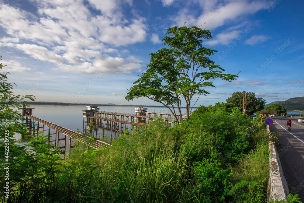 Panoramic natural background of green meadows along the reservoir, surrounding roads and winds and beautiful morning sunlight. Panoramic natural background of green meadows along the reservoir, surrounding roads and winds and beautiful morning sunlight.