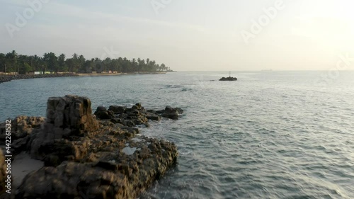 Dawn bright sunlight above sea with rocky shore at Sri Lanka, Salli photo