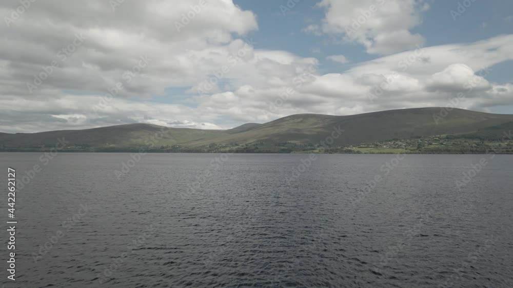 Scenic View Of Blessington Lake (Poulaphouca Reservoir) With Calm Waters In County Wicklow, Ireland. drone backward Scenic View Of Blessington Lake (Poulaphouca Reservoir) With Calm Waters In County Wicklow, Ireland. drone backward