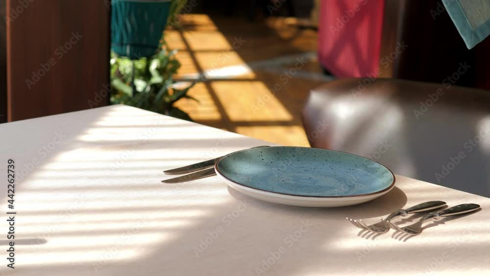 Table setting in an elite restaurant closeup. Men's hands arrange