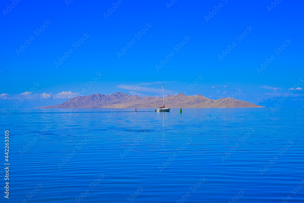 Reflections of the sky reveal a blue lake surface, mysterious and serene. Salt Lake, fourth largest city in the Inland West, Utah, USA. 2016.