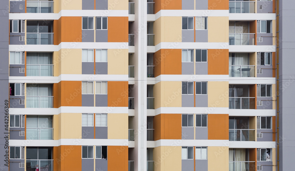 Front view of condominiums in Chorrillos Lima Peru, yellow orange facade of modern apartments