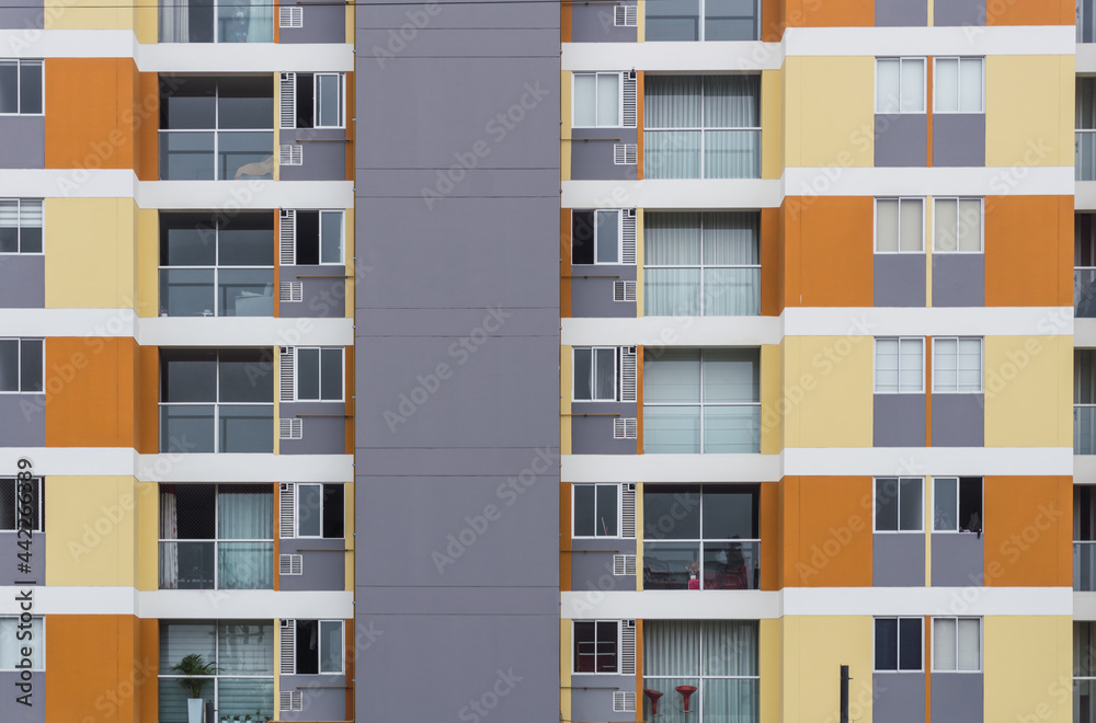 Front view of condominiums in Chorrillos Lima Peru, yellow orange facade of modern apartments