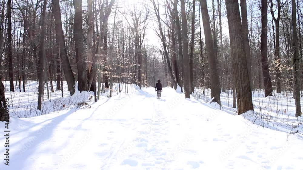 Backview Of A Woman On Deep Snow Road At Sunny Day. - Wide Shot