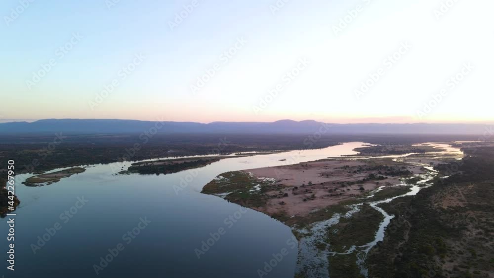 Light Reflection At The River Surrounded With Dry Landscape. aerial