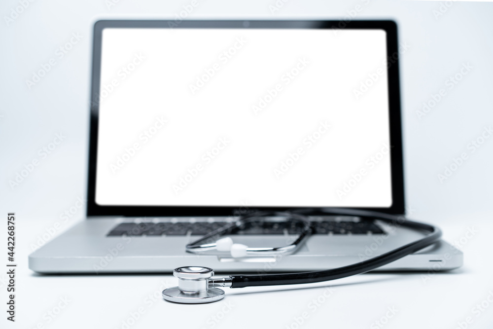 Medical stethoscope left on the laptop computer close up with copy space. Medical stethoscope left on the laptop computer close up with copy space.