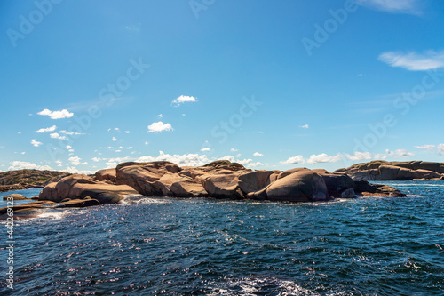 Sea by rocks against sky