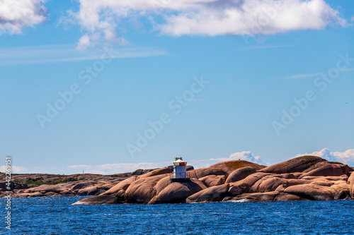 Lighthouse by sea against sky