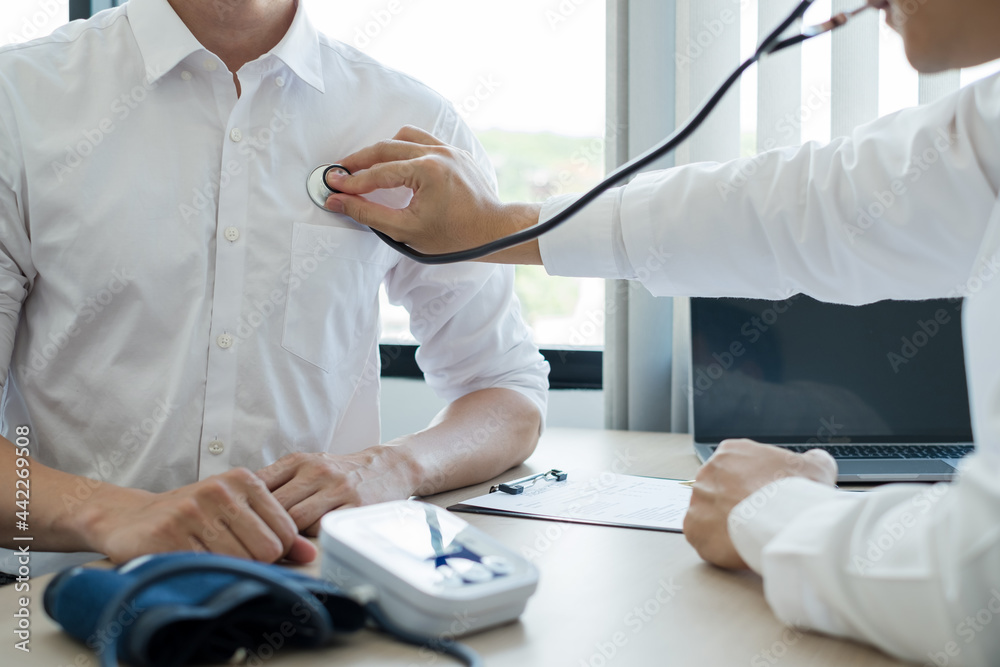 Male doctors perform a pulse test using a stethoscope. Initial health check-up at the hospital. Concepts of treatment and good health Male doctors perform a pulse test using a stethoscope. Initial health check-up at the hospital. Concepts of treatment and good health