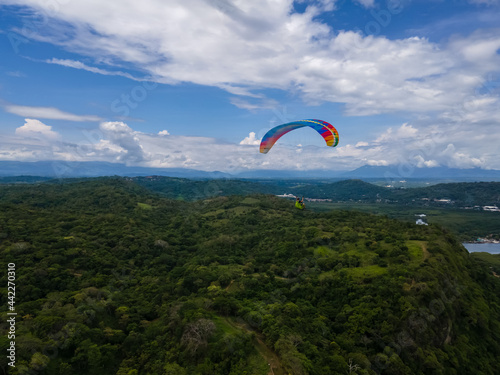 Beautiful aerial view of the extreme sport of paragliding on the Beach and mountains of Costa Rica 