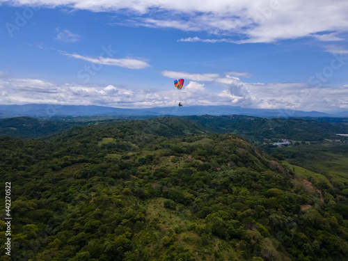 Beautiful aerial view of the extreme sport of paragliding on the Beach and mountains of Costa Rica 