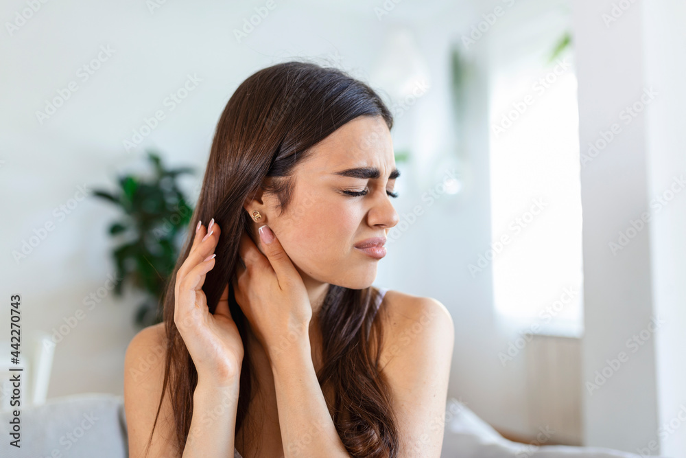 Tired woman massaging stiff sore neck, tensed muscles fatigued from computer work in incorrect posture while feeling hurt joint shoulder back pain ache. Fibromyalgia concept Tired woman massaging stiff sore neck, tensed muscles fatigued from computer work in incorrect posture while feeling hurt joint shoulder back pain ache. Fibromyalgia concept