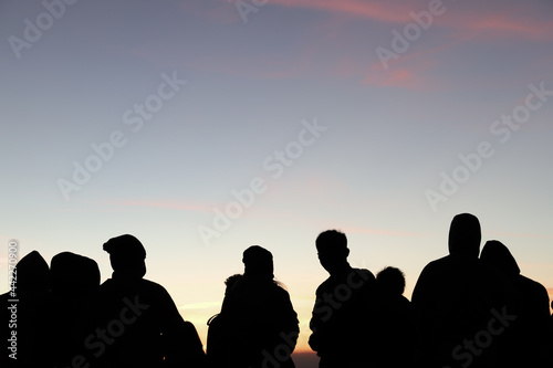 Silhouette scenery of group of people in morning dawn. 