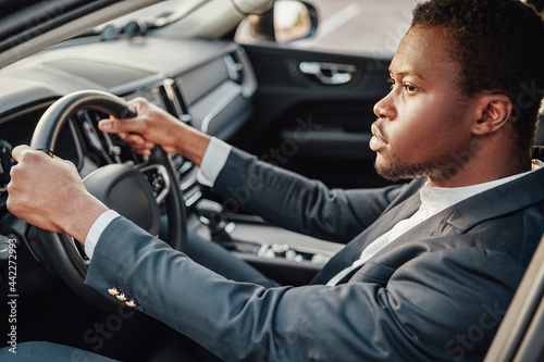 Businessperson of african descent sitting inside car