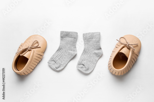 Baby shoes and socks on white background
