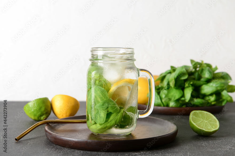 Mason jar of lemonade with basil on light background Mason jar of lemonade with basil on light background