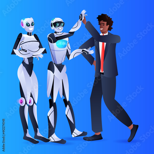 businessman and robots giving each other high five during meeting agreement partnership artificial intelligence